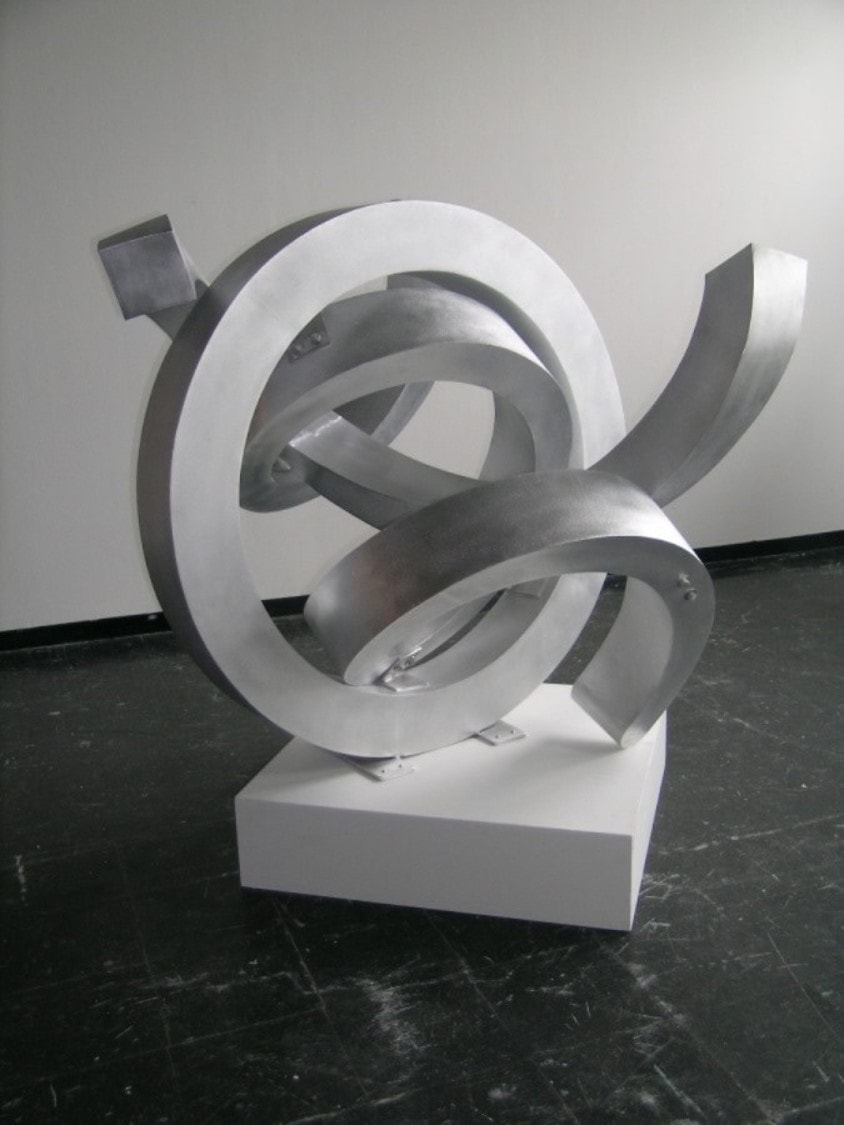 Abstract silver aluminum sculpture with curves